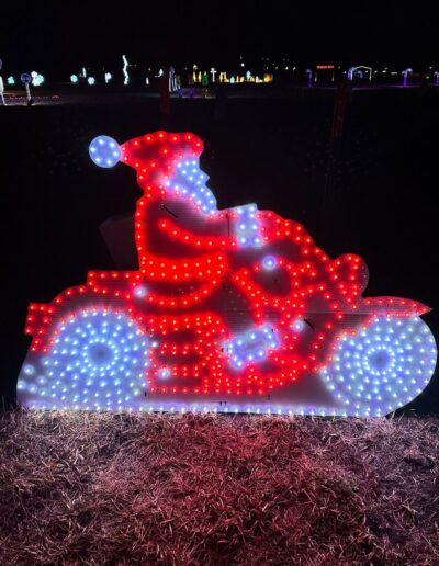 A red and white lit up display of Santa on a motorcycle for the Magical Lights of Lincoln family produced Christmas lights show at the Lancaster Event Center