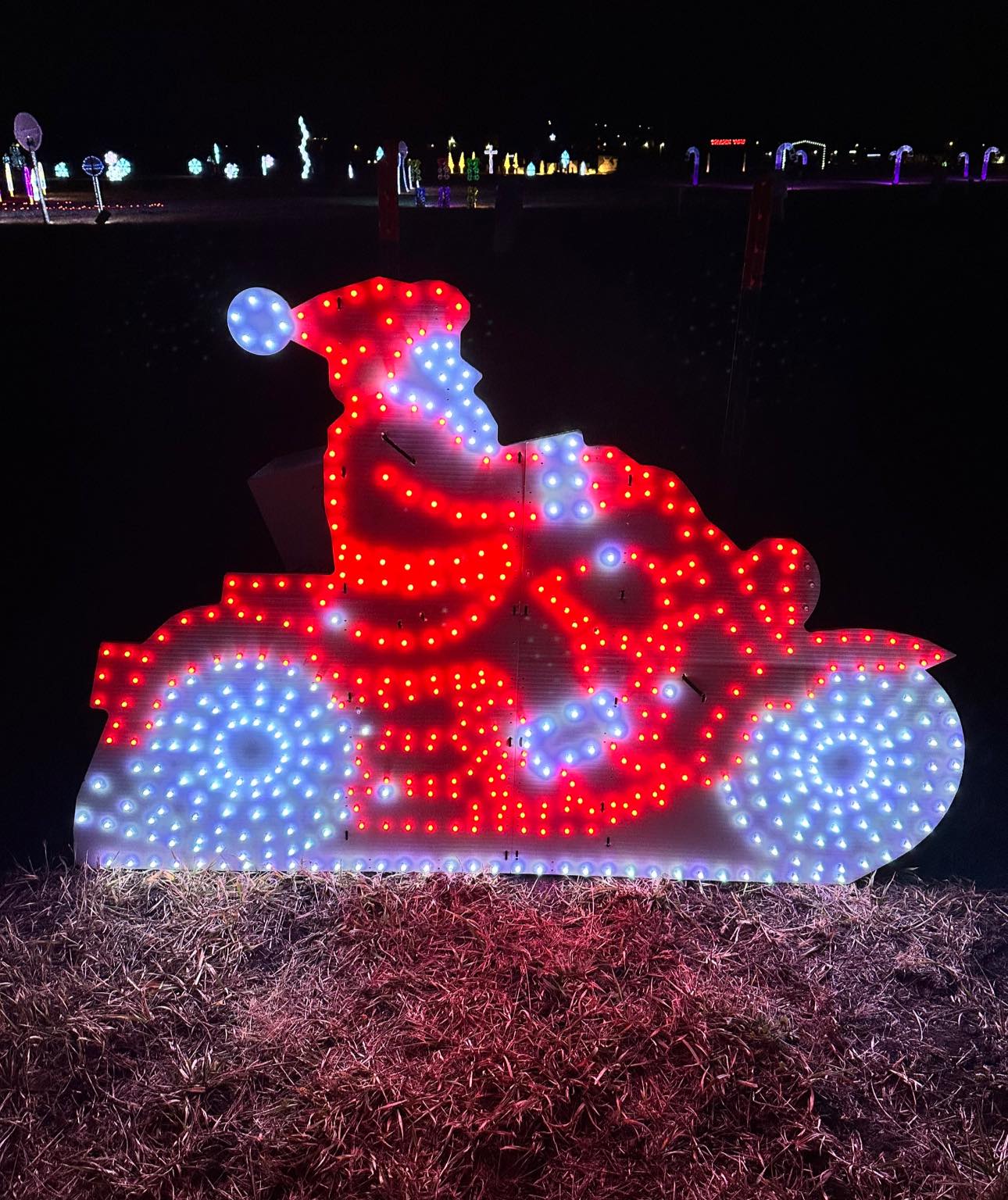 A red and white lit up display of Santa on a motorcycle for the Magical Lights of Lincoln family produced Christmas lights show at the Lancaster Event Center